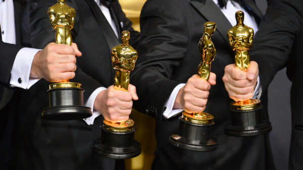 Men holding Oscars during awards season